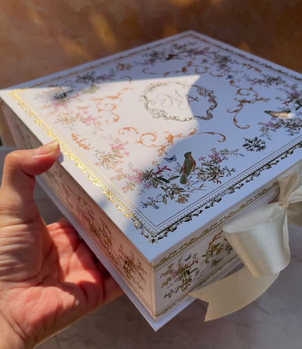 Luxury white gift box with ornate floral patterns and gold foil detailing